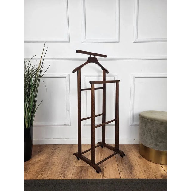 Vintage 1970s Italian wood dressboy valet stand, with classic carved column and pedestals completed by the fine and...