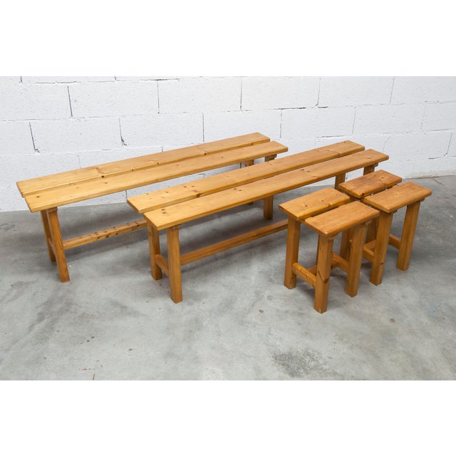 Set of 2 benches and 2 matching stools in solid pine. Some scratches are visible on the seats. The seats are clean and...
