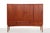 Vintage teak Danish design highboard. This cabinet is made of teak and has an oak base. The cabinet has four sliding doors...