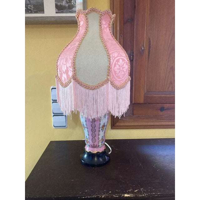 Introducing our 1940's fine porcelain table lamp, a timeless piece that exudes elegance and charm. Crafted from floral...