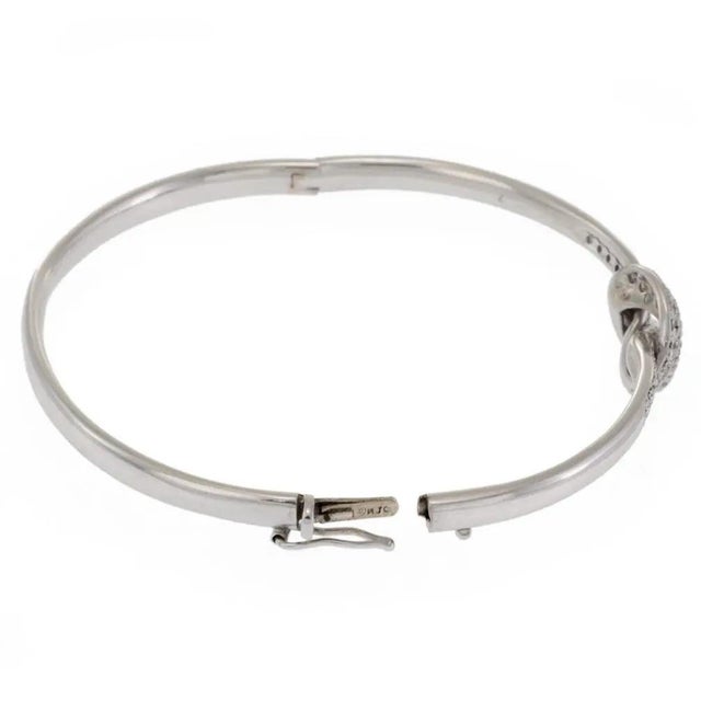 This elegant authentic vintage bangle bracelet is by Roberto Coin, crafted from 18k white gold featuring a high polished...