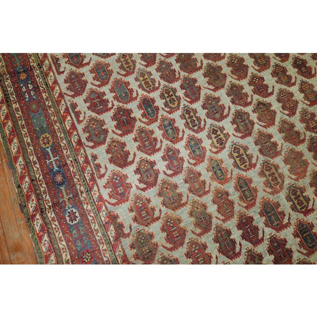 A remarkable tribal Ghashgai Gallery rug with an blue background, teal border with an all-over paisley motif pattern. The...