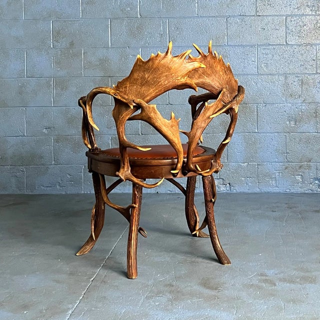 Sculptural Black Forest armchair crafted from interlaced stag and fallow deer antlers, circa 1900. Its distinctive...