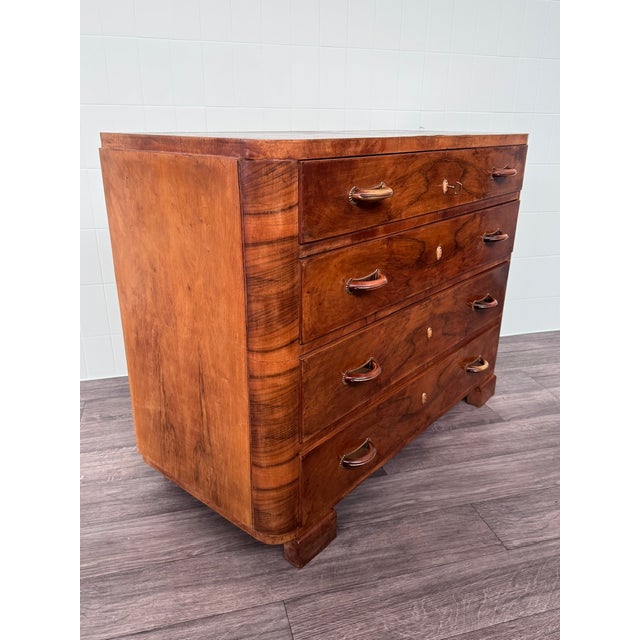 This is an elegant chest of drawers dating back to the 1930s. The piece features a highly figured burl veneer, displaying...