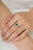 This elegant cluster ring is crafted in 925 sterling silver, featuring a 0.61-carat natural emerald in an octagonal cut...