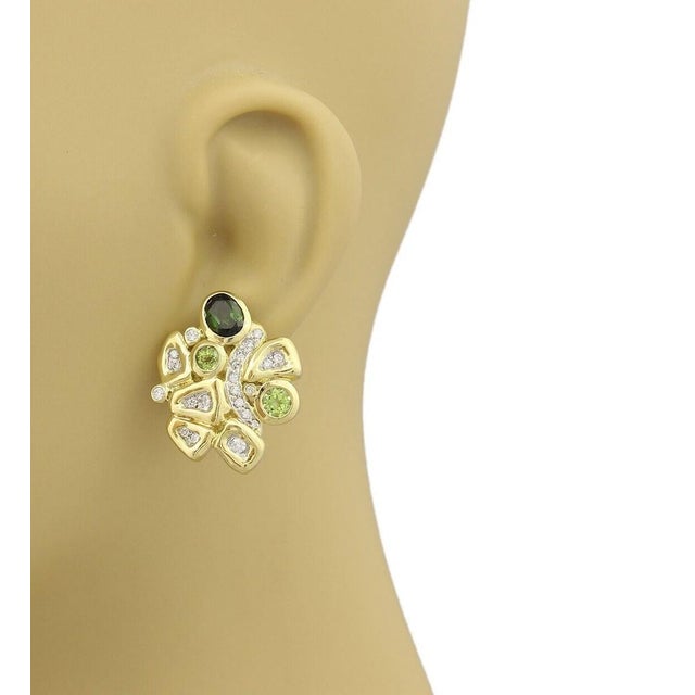 The Seidengang Diamonds Green Tourmaline & Peridot 18k Yellow Gold Fancy Earrings are a stunning pair of vintage pieces...
