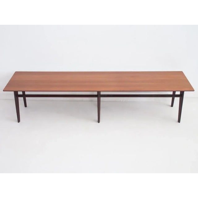 Long mahogany coffee table of console with tapering legs. Made in Italy by Dassi Mobili Moderni in the 1960s.