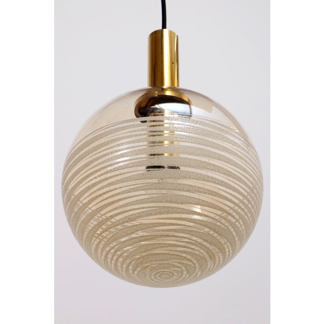 Discover the allure of lighting with a story through our Vintage Glashütte Limburg Hanging Lamp Set. Crafted in Germany...