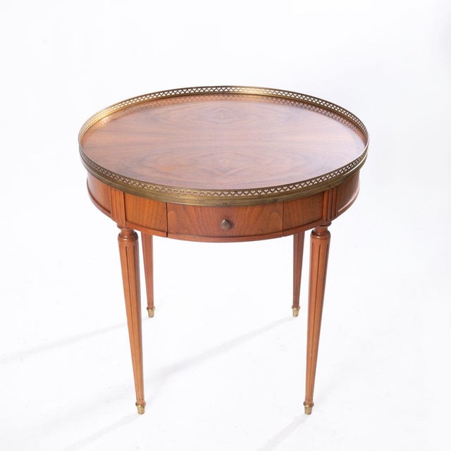 Round table with brass gallery and brass top feet. Has one dovetailed drawer. Would look marvelous in living room or...