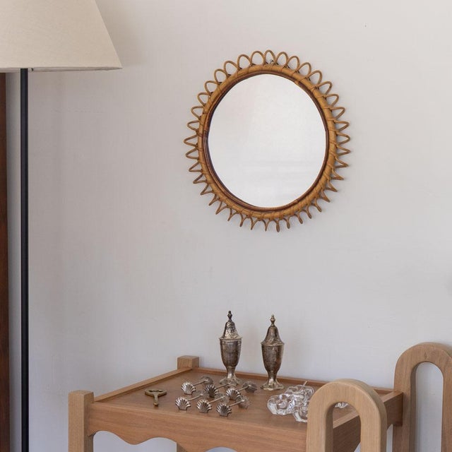Beautiful circular rattan mirror from Italy, 1960s. Unique design with spiral rattan detailing encompassing the mirror....
