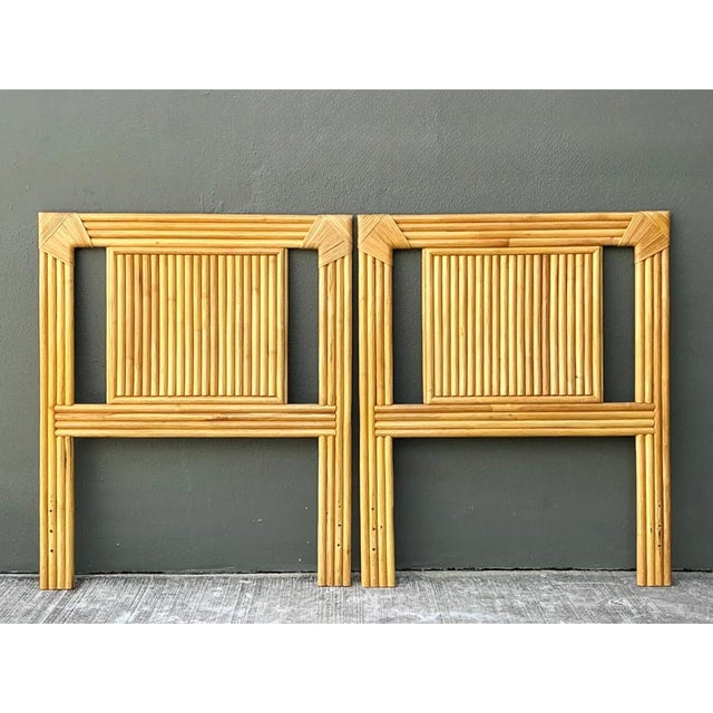 This vintage pair of twin headboards is built entirely from honey-toned rattan poles, grouped in tight parallel bundles to...