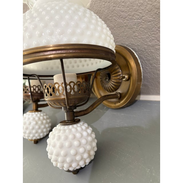 This elegant pair of vintage wall sconces dates to the mid-20th century (circa 1950s–1970s) and features classic hobnail...