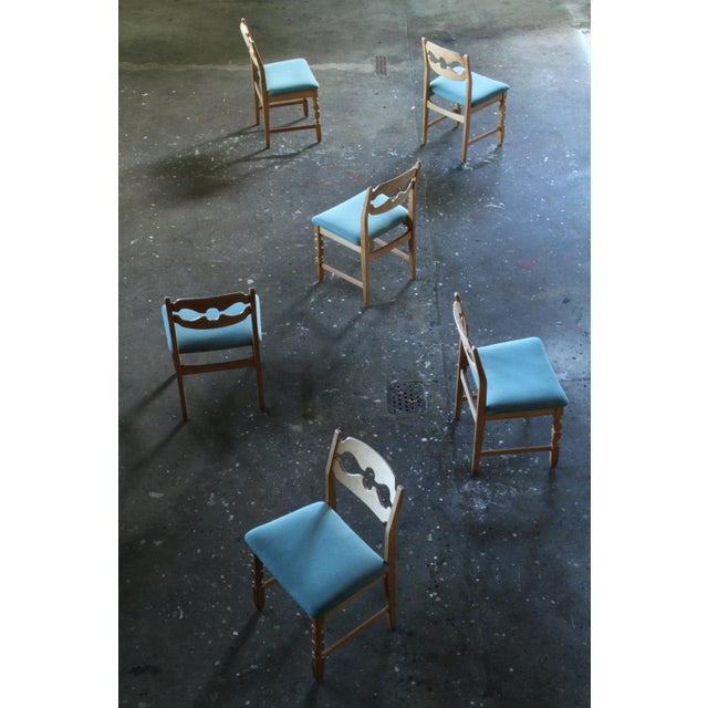 Henning Kjærnulf's striking dining chairs, crafted from oak and showcase a captivating blend of brutalist/Baroque and Mid-...