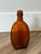 Vintage one-pint amber glass liquor or medicinal flask, similar to mid-20th-century whiskey or utility bottles.