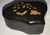 Unusual curves make this black lacquer snuff box unique. Tiny flowers decorate the top. This is a nice collectible to add...