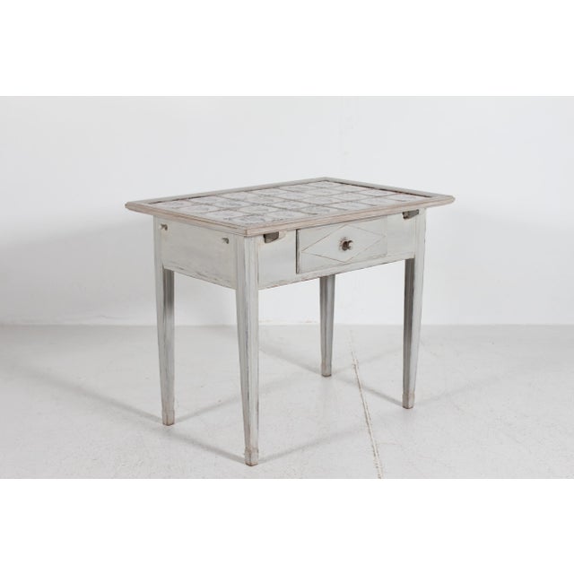 Antique Danish or perhaps Swedish empire tile top table with dutch tiles and 1 drawer. It's made in the 19th century...