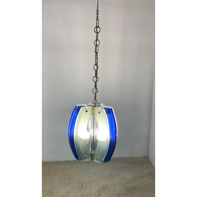 Chandelier with three lights, colored glass attributable to Fontana Art. Magnificent composed of 9 colored glasses that...