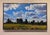This oil on panel artwork captures a vibrant landscape where billowing clouds drift across a bright blue sky, set against...