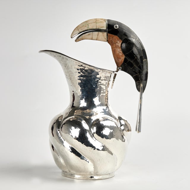 Standout mid century pitcher handcrafted in hammered copper with a silver plate finish in classic form featuring a stone...