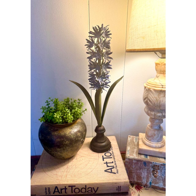 A charming vintage tole hyacinth sculpture featuring layered hand-formed metal blossoms in a soft pink tone rising above...