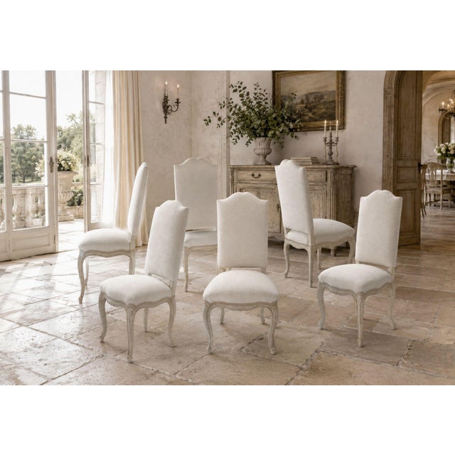 An elegant set of six 19th century Louis XV style dining chairs, showcasing gracefully carved beechwood frames with...