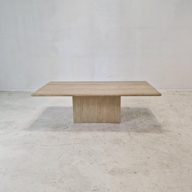 Very nice rectangle shaped Italian coffee or side table handcrafted out of travertine, 1980s. It is made of beautiful...
