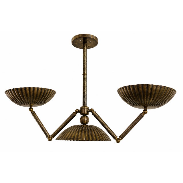 Bring timeless character to your space with this bronze 3-light chandelier, handcrafted with fluted metal shades and...