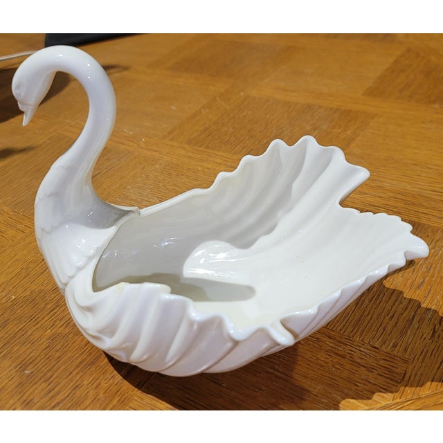 Traditional yet modern, a graceful porcelain swan by Lenox to use as a cany or nut bowl or even an herb planter. Green and...