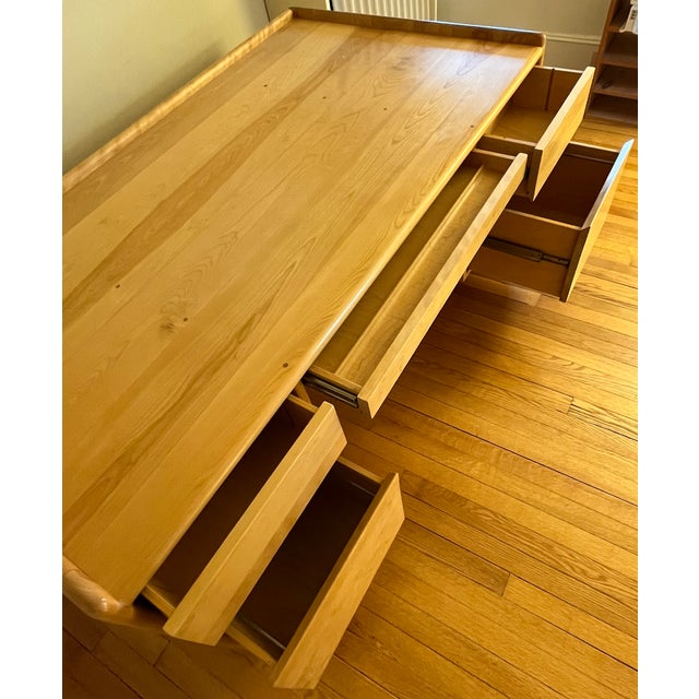 Handsome, generously sized five-drawer executive desk with softly rounded edges, a raised border around the work surface,...