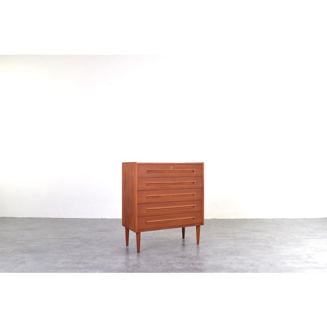 This teak chest of drawers was manufactured in Denmark in the 1960s. The furniture has been professionally and carefully...
