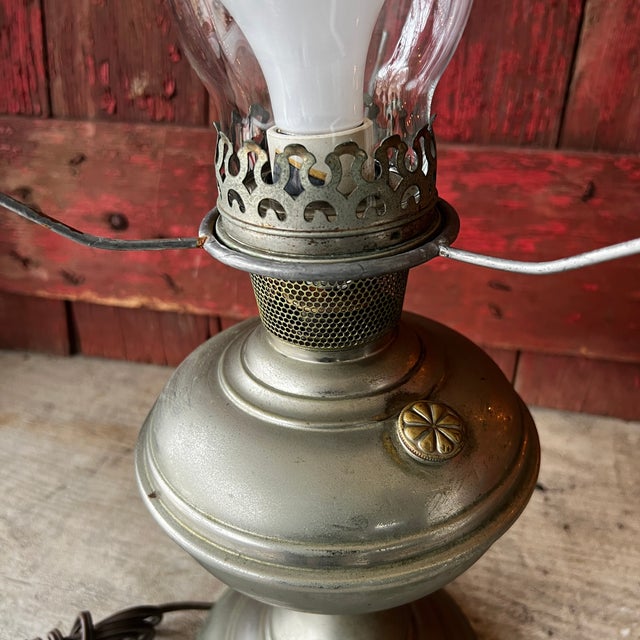 This vintage Aladdin lamp, converted to electric, combines antique charm with modern utility. Features metal construction,...