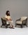 This pair of 20th century Mid-Century organic modernism faux bamboo upholstered armchairs from France, woven in dark faux...