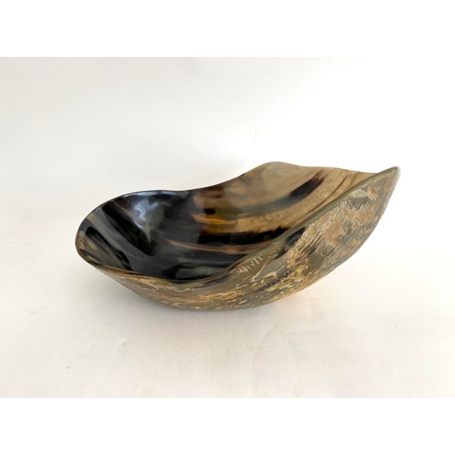 Hand-crafted free form bowl made from steer horn with a flat base. Each one is unique in coloration and shape. This one...