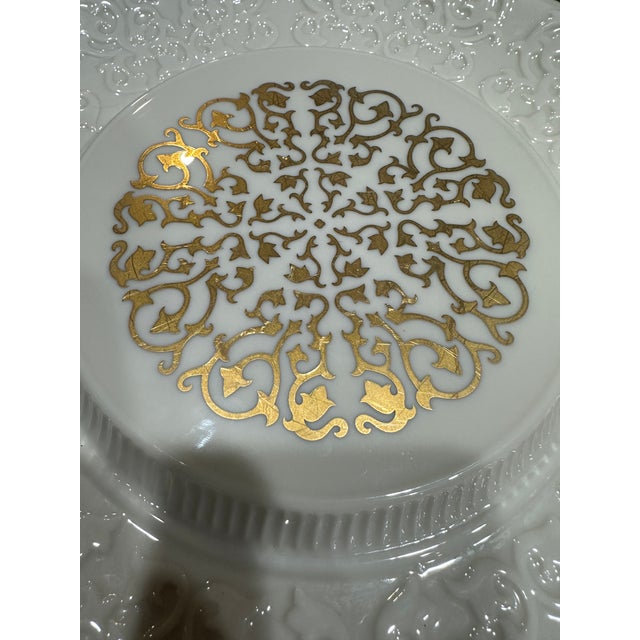 An elegant vintage decorative porcelain serving plate by Lenox featuring richly embossed scrollwork borders and an ornate...