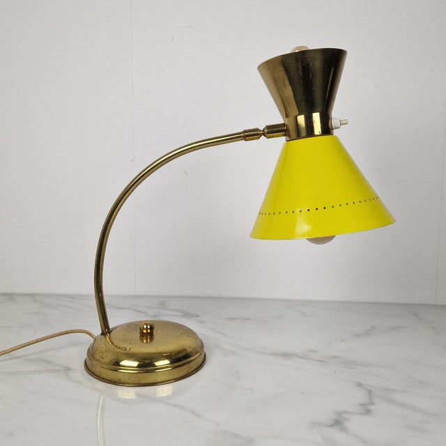 Elegant mid-century table lamp, attributed to hala zeist, executed in brass with a striking yellow lacquered metal shade...