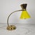 Elegant mid-century table lamp, attributed to hala zeist, executed in brass with a striking yellow lacquered metal shade...