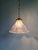 Holophane pendant light in clear fluted glass with a brass mount, 1930s. The shade is signed "holophane" inside the neck...