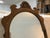 With a scrolled top and tole pained flowers in middle of a rounded crest, this late 19th to early 20th century mirror...