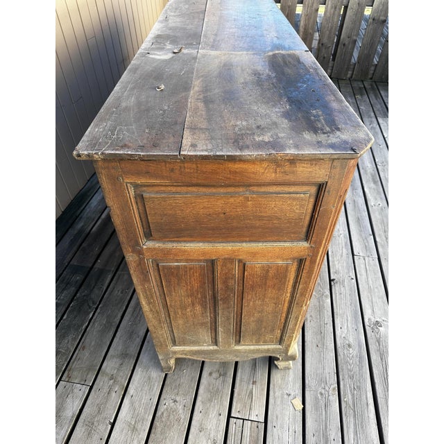 An imposing 18th-century French sideboard, from the Louis XV-Louis XVI transitional period, crafted from solid walnut. It...