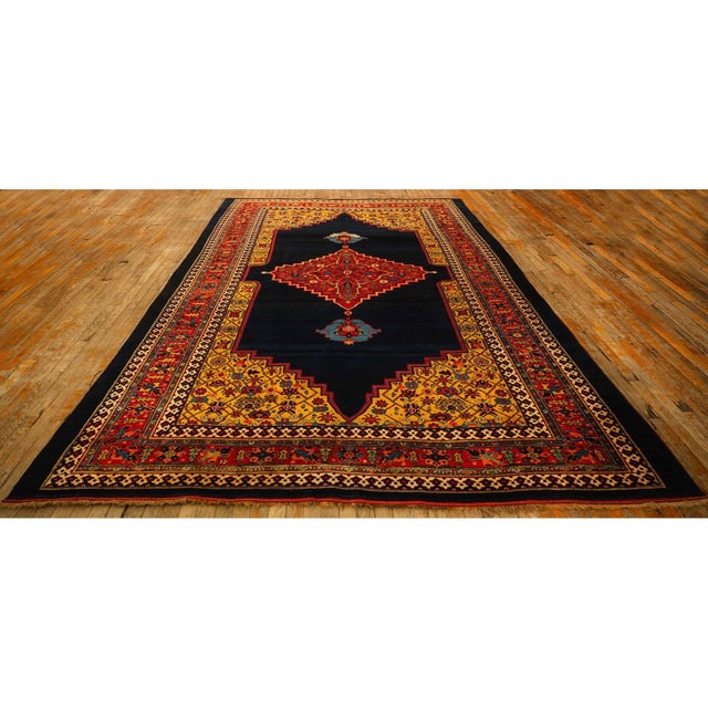 A magnificent room-sized Antique Persian Bijar carpet, circa 1880. Measuring 7' 8" x 12', this piece is a testament to the...