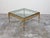 An Italian gilt bronze coffee table from the mid 20th century, with glass top and ring motifs. Created in Italy during the...
