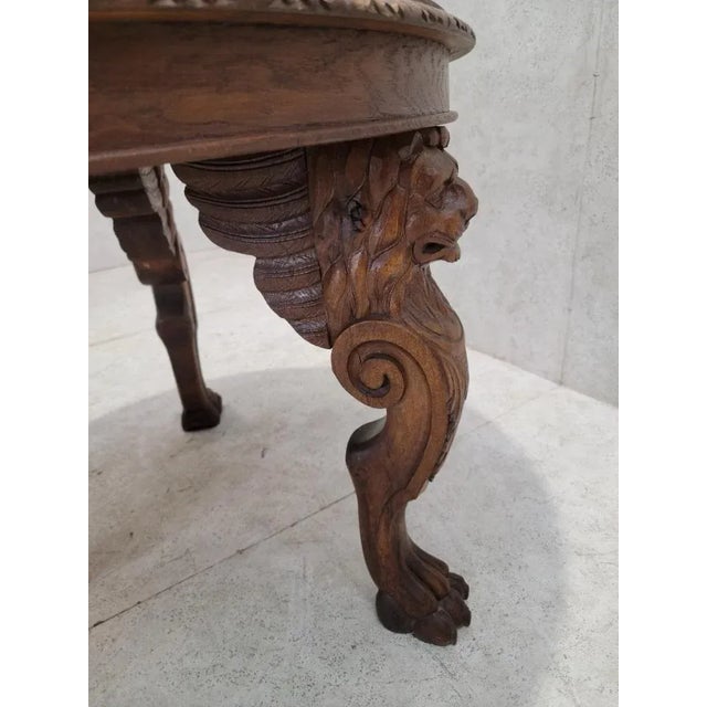 Antique French Carved Figural Oak Entry Table Featuring an antique French finely carved on 3 winged lions-head legs with...