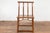 A Chinese late Qing Dynasty period chair from the early 20th century with vertical slats, pierced apron, pillar strut...