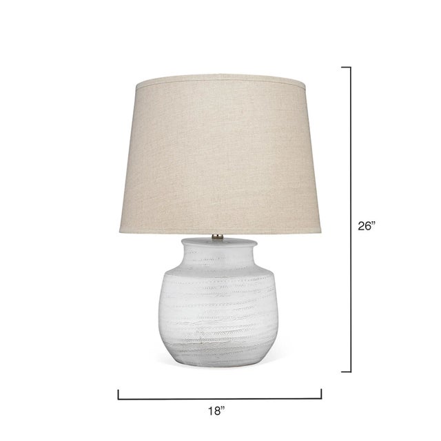 This off-white table lamp has a subtle texture traced around the lamp body, creating a coastal elegance yet whimsical...