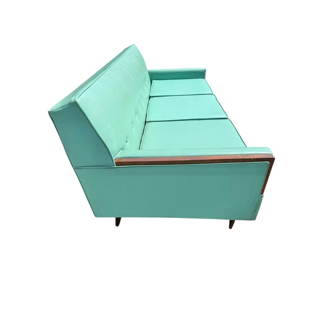 Make a bold mid-century statement with this stunning 1960s turquoise sofa, featuring its original turquoise vinyl...
