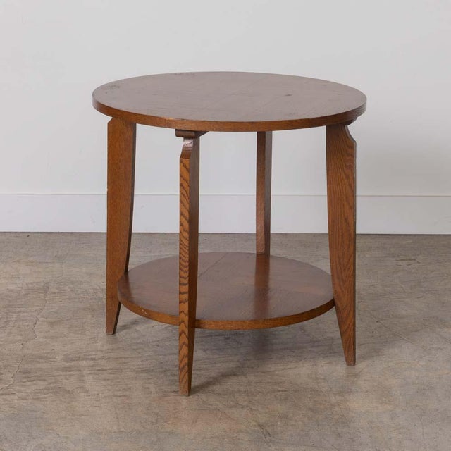 Incredible Art Deco wood gueridon table from France, 1930s. Large circular top with lower shelf and four angular feet....