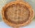 Vintage woven wicker basket with handles. Oval shaped. Larger size. Measures 17 1/2” long x 15” wide x 2 1/2” tall.