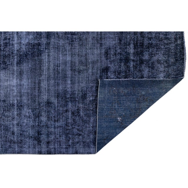 Transform your space with this Vintage Overdyed Persian Rug in deep Midnight Indigo. Hand-knotted from wool, it features a...