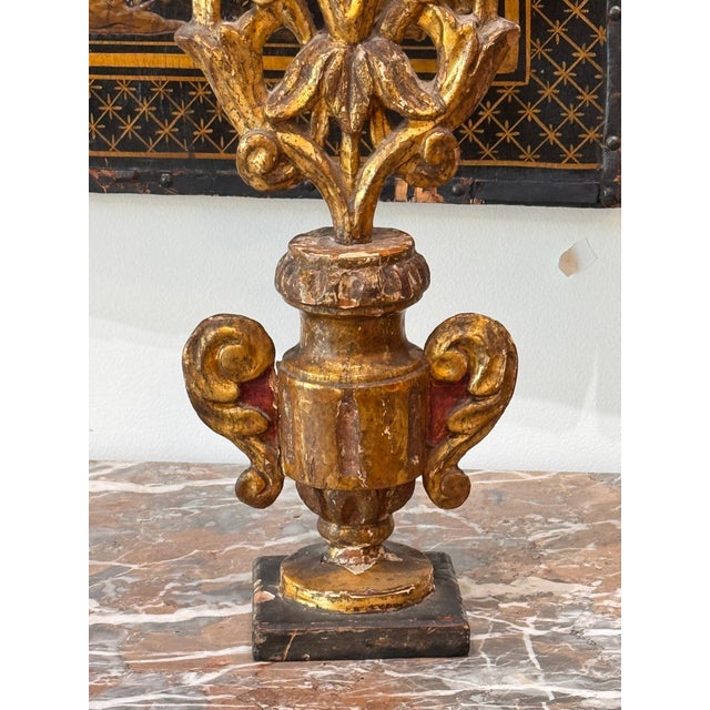 A pair of Italian carved giltwood altar prickets, each with five iron spikes rising from carved bobèches arranged among...