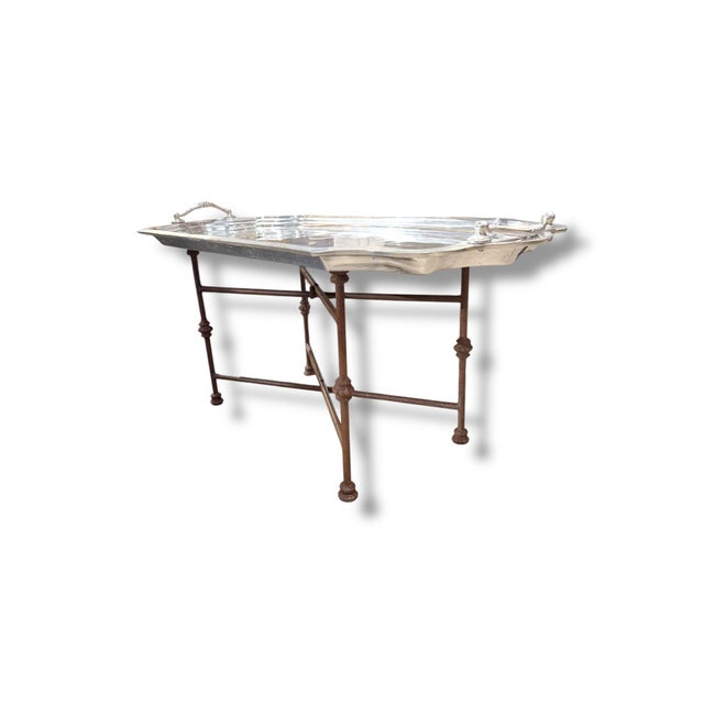 Vintage pewter and iron coffee table featuring a large removable serving tray top and elegant iron base. The oversized...